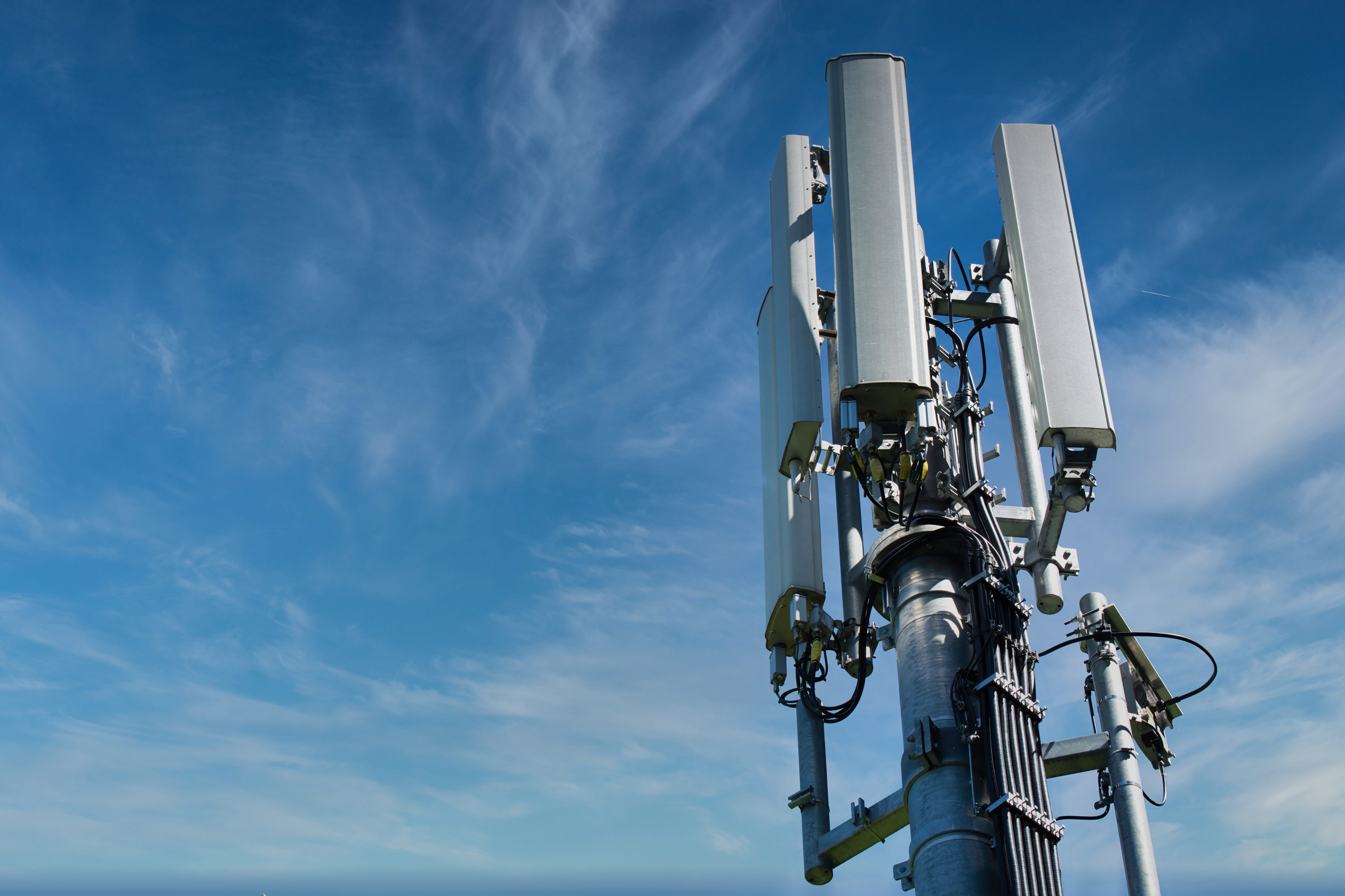 Blue sky with clouds and a 5g data center tower.